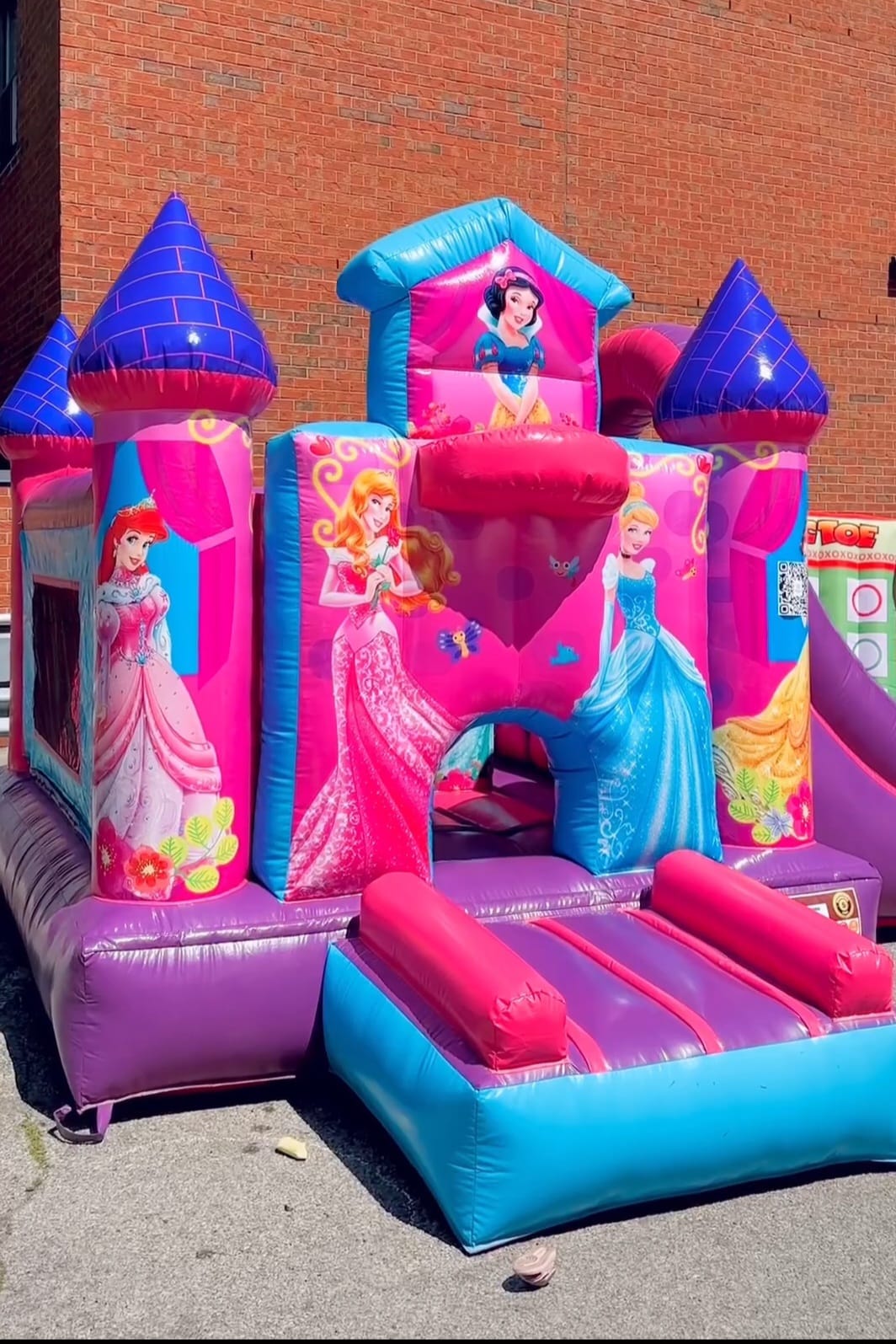 Disney Princess bouncy castle with pink design and side inflatable slide for girls’ birthday parties