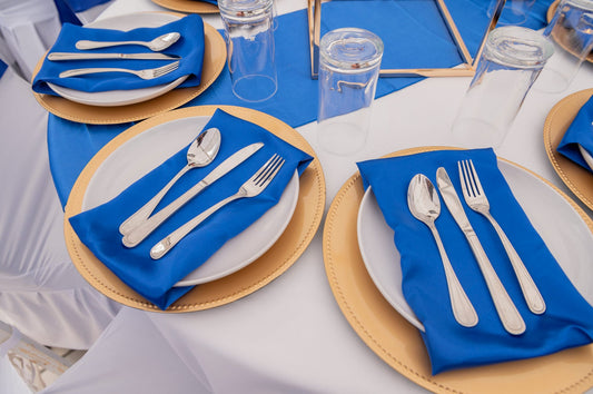 Decorative event napkins in assorted colors folded on table setting