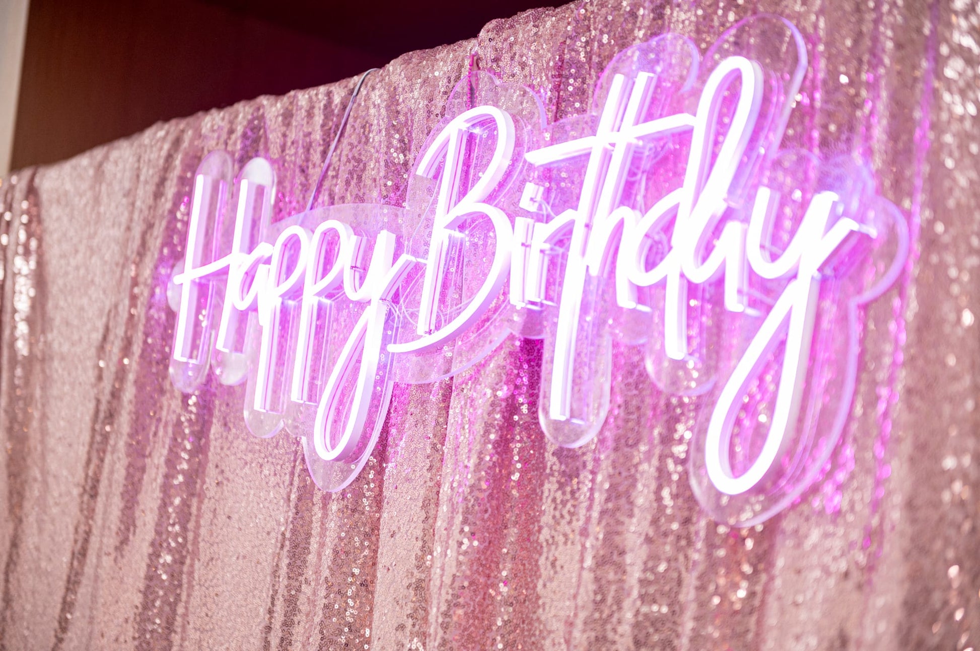 LED Happy Birthday sign for events glowing in white against backdrop