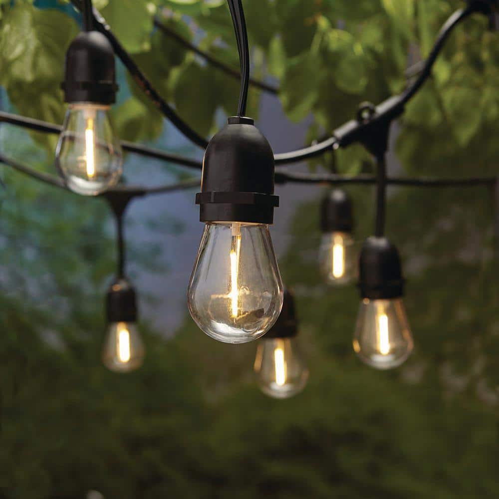 Bulb outdoor string lights hanging across a white canopy for garden or event lighting